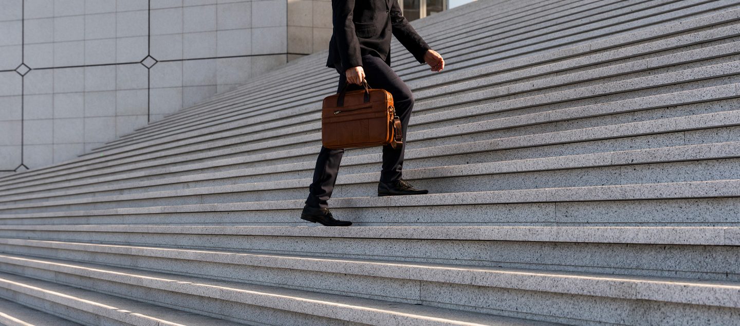Man walking up a large stairway