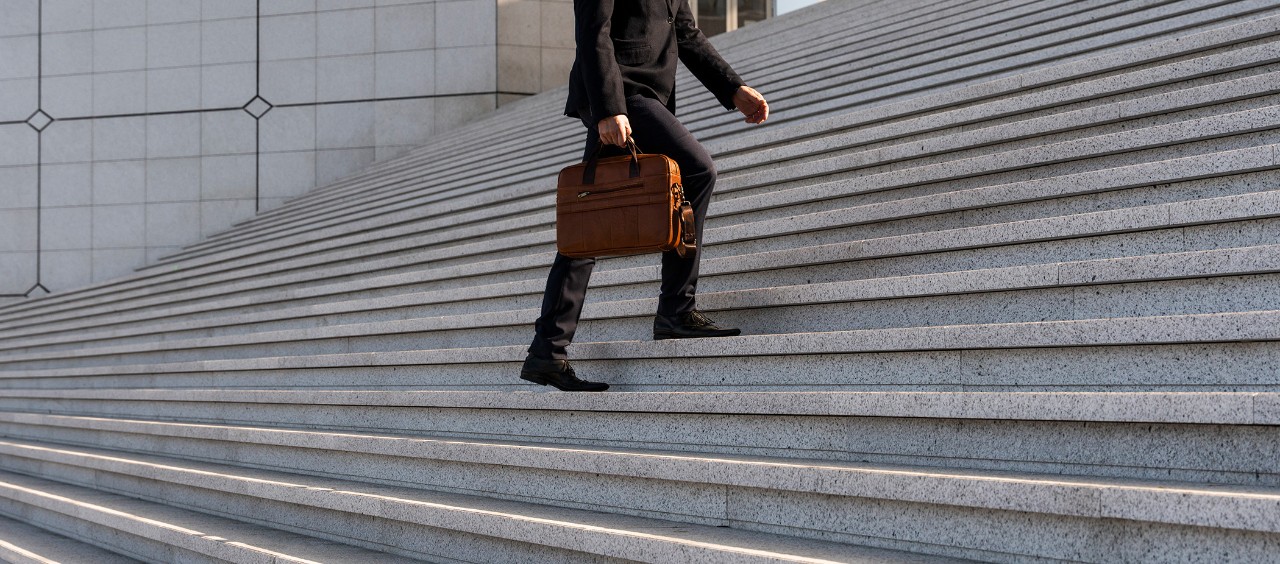 Man walking up a large stairway